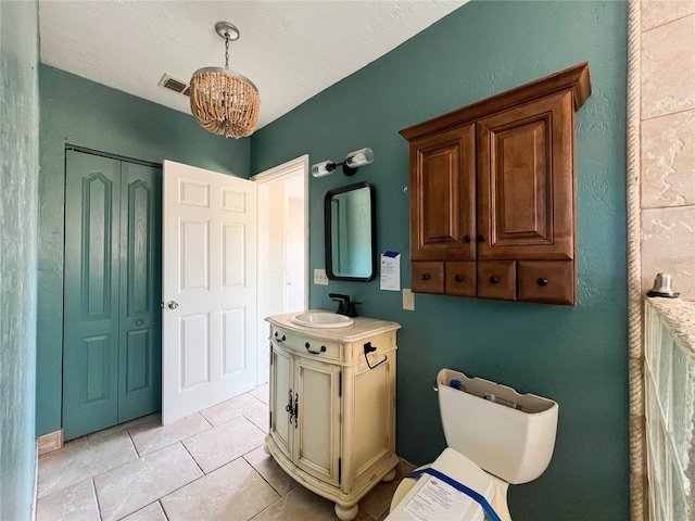 bathroom with tile patterned floors, vanity, and toilet