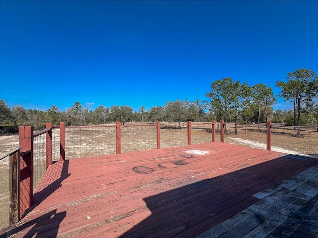 wooden deck with a rural view