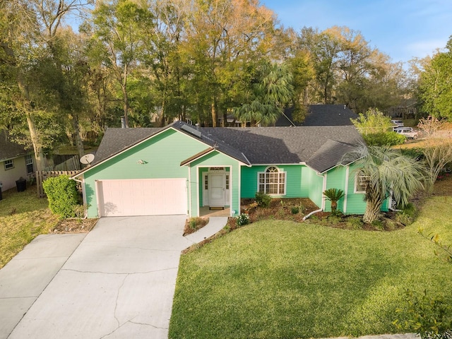 ranch-style house featuring a garage, concrete driveway, and a front yard