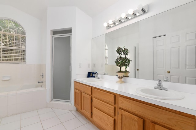 bathroom featuring a sink, a shower stall, a bath, and tile patterned floors