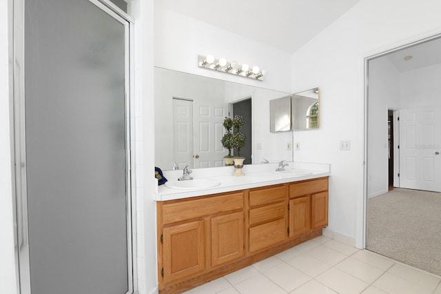 bathroom featuring double vanity, tile patterned flooring, a sink, and a shower stall