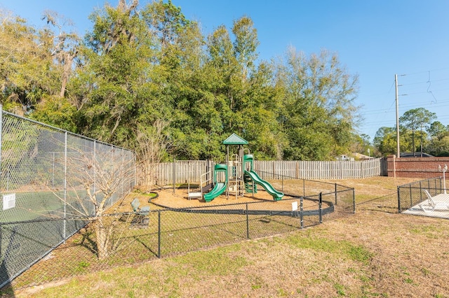 community playground featuring a lawn and fence