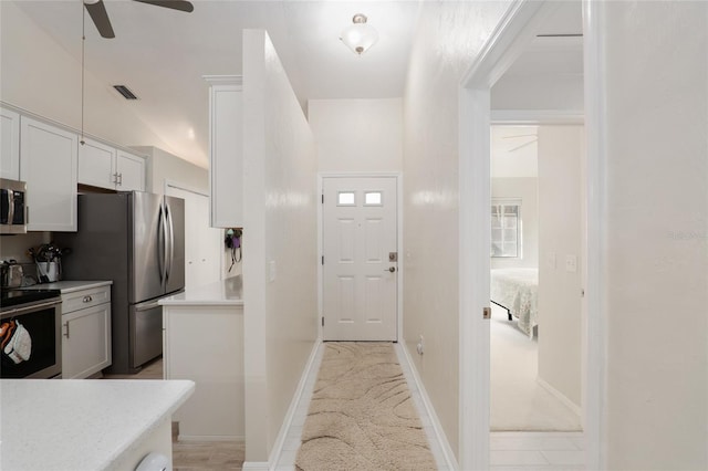 kitchen featuring white cabinetry, ceiling fan, and stainless steel appliances