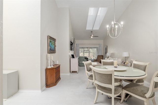 dining area with an inviting chandelier, a skylight, and high vaulted ceiling