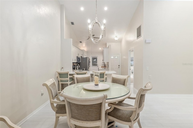 dining room with sink and an inviting chandelier