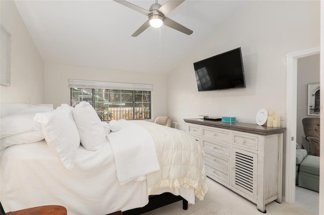 carpeted bedroom featuring lofted ceiling and ceiling fan