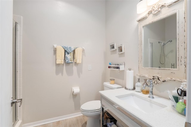 bathroom featuring a shower with door, wood-type flooring, sink, and toilet