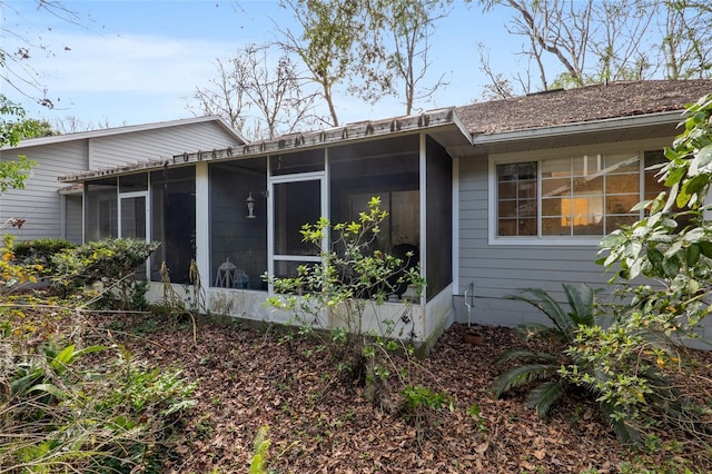 view of home's exterior with a sunroom