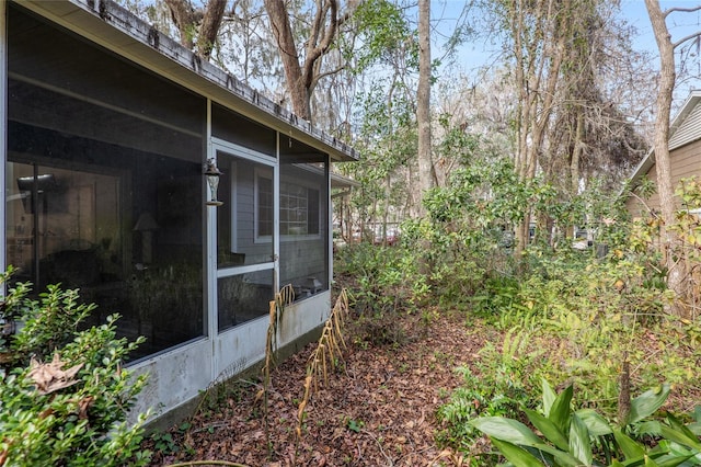 view of side of property featuring a sunroom