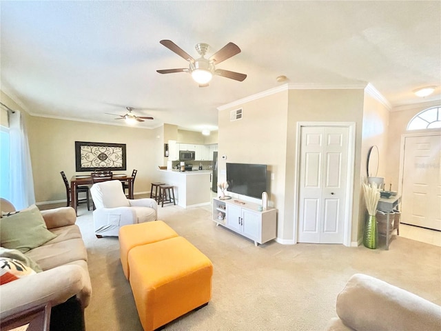 carpeted living room featuring crown molding and ceiling fan