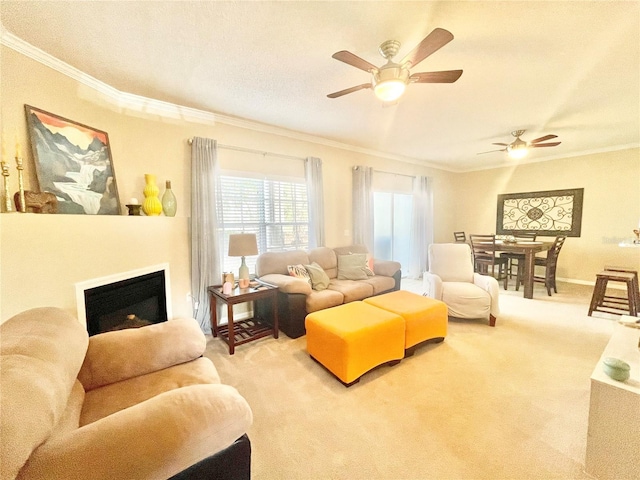 living room featuring ceiling fan, ornamental molding, and light carpet