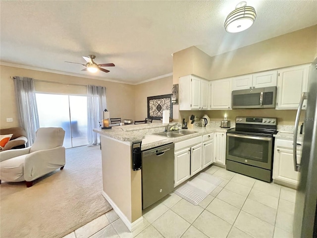 kitchen featuring stainless steel appliances, white cabinetry, sink, and kitchen peninsula