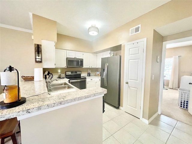 kitchen with sink, light tile patterned floors, white cabinetry, stainless steel appliances, and kitchen peninsula