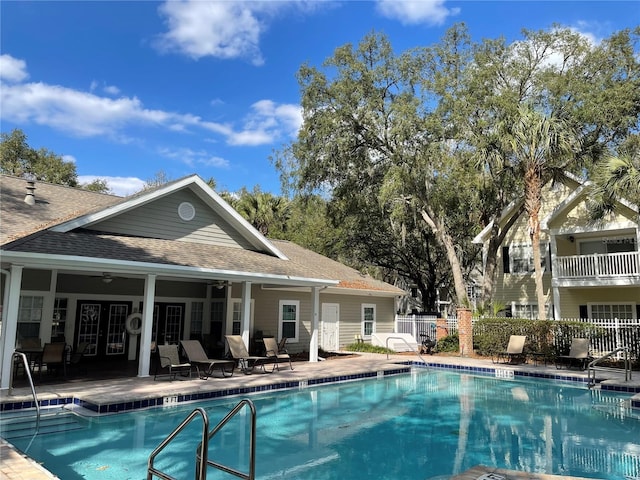 view of swimming pool with ceiling fan and a patio area