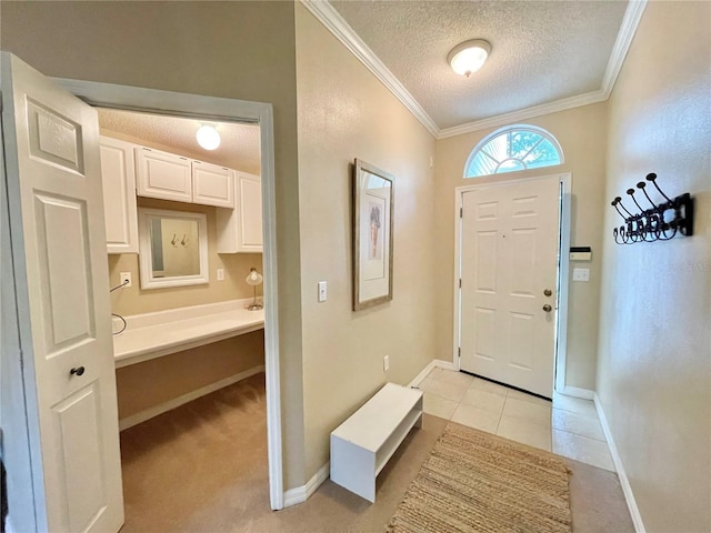 10000 SW 52nd Ave Unit 103, Gainesville, FL 32608 - entryway featuring ornamental molding, baseboards, light tile patterned flooring, and a textured ceiling