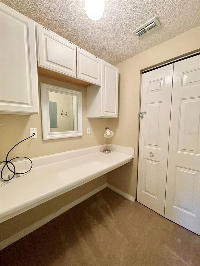 10000 SW 52nd Ave Unit 103, Gainesville, FL 32608 - interior space with a textured ceiling, light colored carpet, electric panel, visible vents, and baseboards