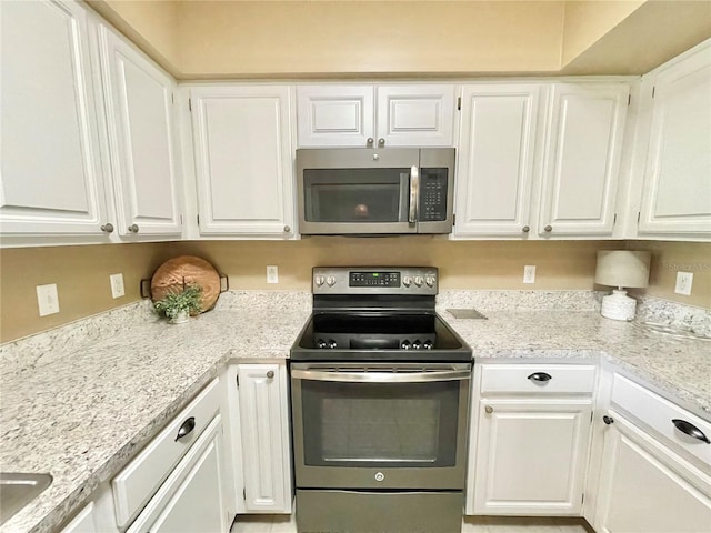 10000 SW 52nd Ave Unit 103, Gainesville, FL 32608 - kitchen featuring appliances with stainless steel finishes and white cabinetry