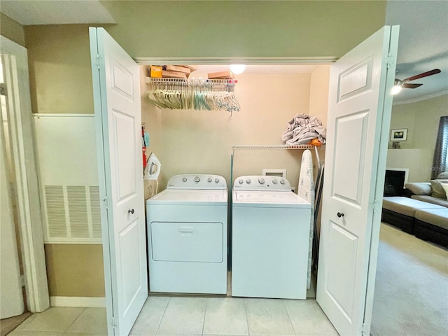 10000 SW 52nd Ave Unit 103, Gainesville, FL 32608 - clothes washing area with baseboards, light tile patterned floors, laundry area, ceiling fan, and washer and dryer