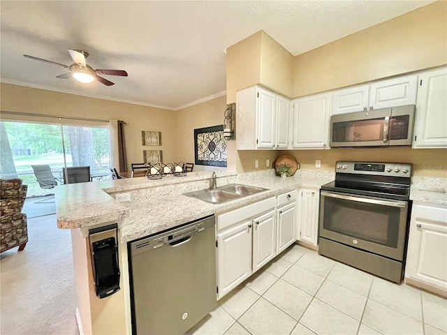 10000 SW 52nd Ave Unit 103, Gainesville, FL 32608 - kitchen featuring a peninsula, a ceiling fan, light countertops, a sink, and stainless steel appliances