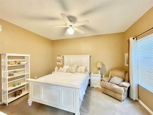 10000 SW 52nd Ave Unit 103, Gainesville, FL 32608 - bedroom featuring light colored carpet, a ceiling fan, and a textured ceiling