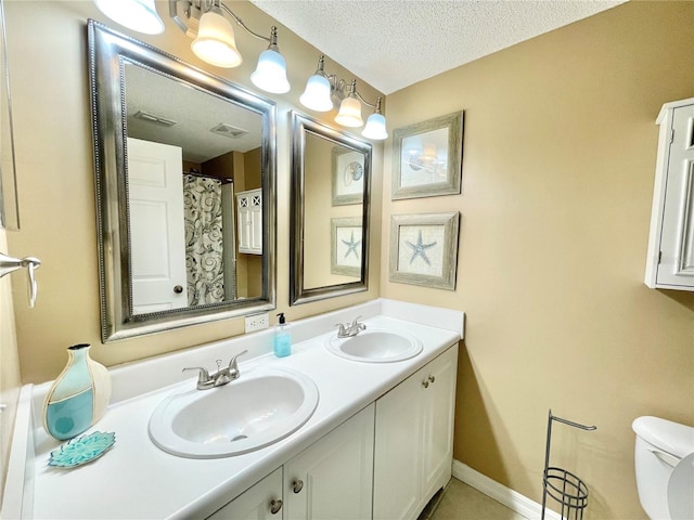 10000 SW 52nd Ave Unit 103, Gainesville, FL 32608 - full bath with a sink, visible vents, toilet, and a textured ceiling