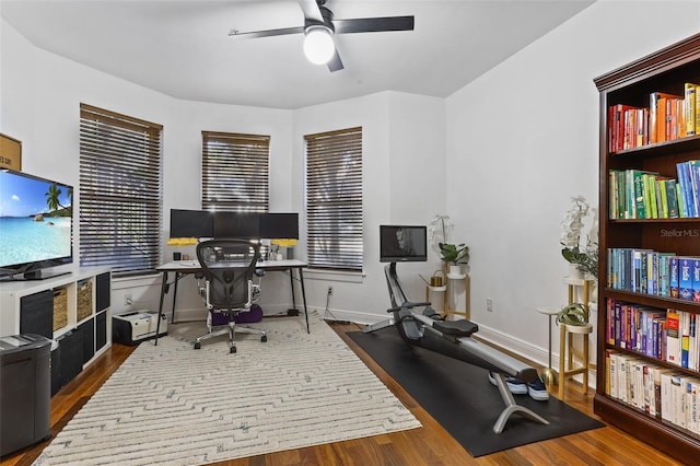 home office with hardwood / wood-style flooring and ceiling fan