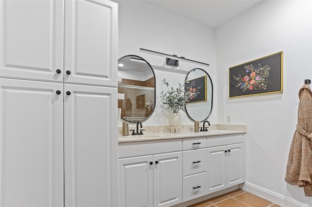 bathroom featuring vanity, a shower with shower door, and tile patterned floors