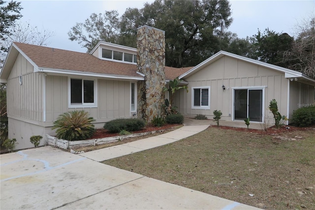 rear view of property featuring a yard