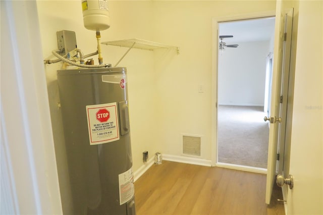 utility room featuring water heater