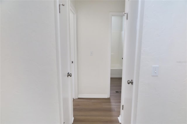 corridor featuring wood-type flooring