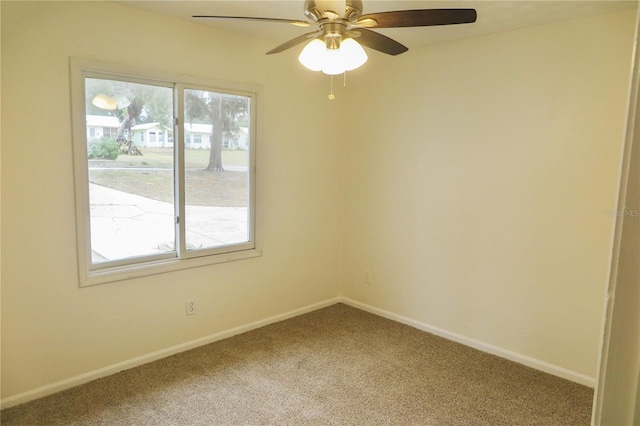 carpeted spare room with plenty of natural light and ceiling fan