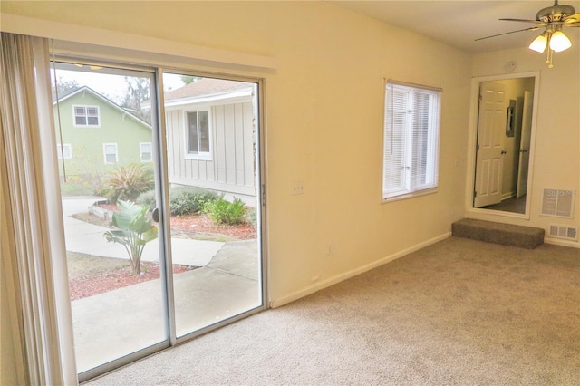 doorway to outside featuring carpet flooring and ceiling fan