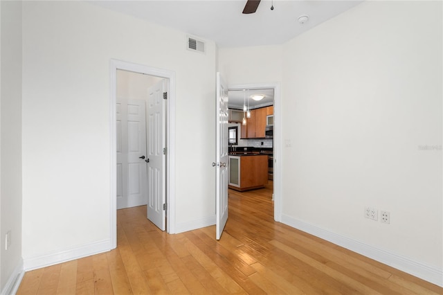 interior space with ceiling fan and light hardwood / wood-style floors