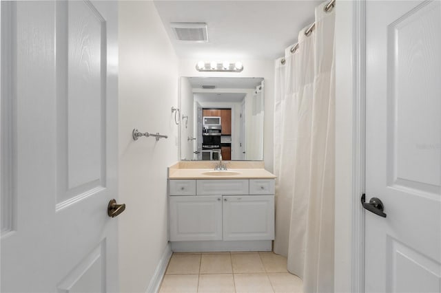 bathroom featuring tile patterned floors and vanity