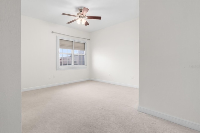 empty room with ceiling fan and light colored carpet