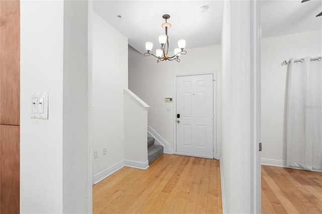 entrance foyer with hardwood / wood-style flooring and a notable chandelier