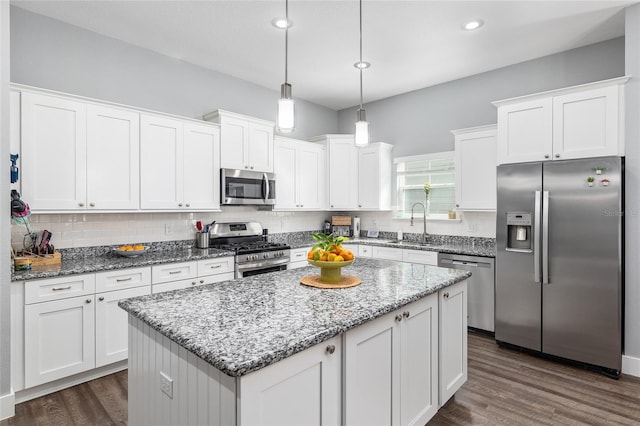 kitchen with white cabinetry, stainless steel appliances, and a center island