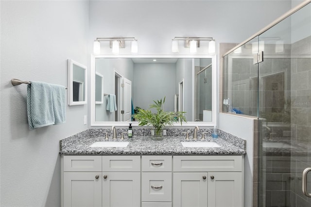 bathroom with walk in shower and vanity