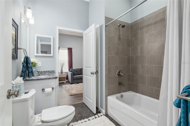 full bathroom with shower / bathtub combination with curtain, vanity, and toilet