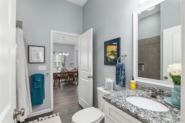 bathroom with vanity, tile patterned floors, a chandelier, and toilet