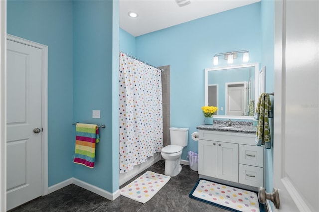 bathroom with vanity, tile patterned floors, and toilet