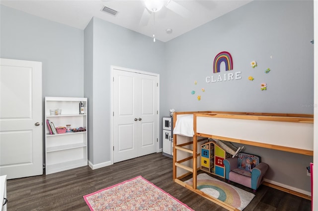 bedroom with dark hardwood / wood-style floors and ceiling fan