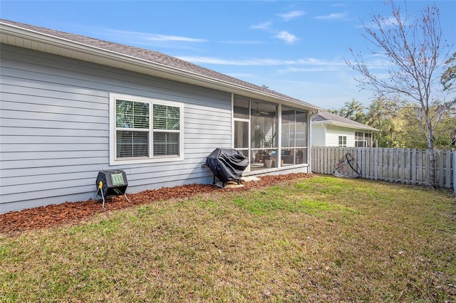 back of house with a lawn and a sunroom