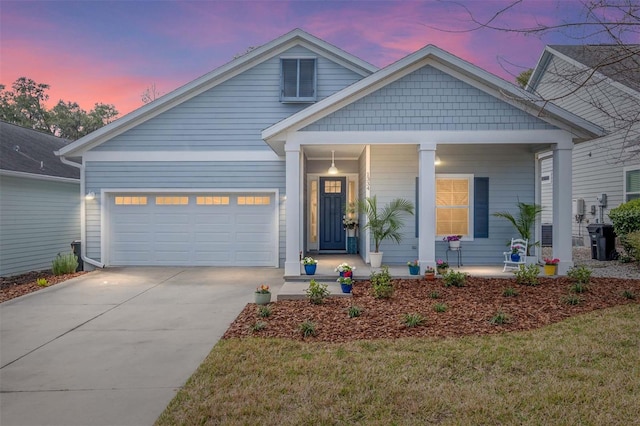 view of front of house featuring a porch, a garage, and a lawn