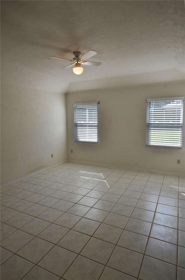 unfurnished room with ceiling fan and light tile patterned flooring