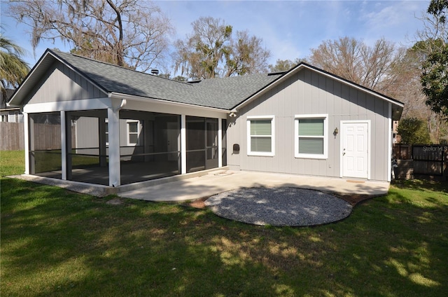 back of property with a yard, a sunroom, a patio, and fence