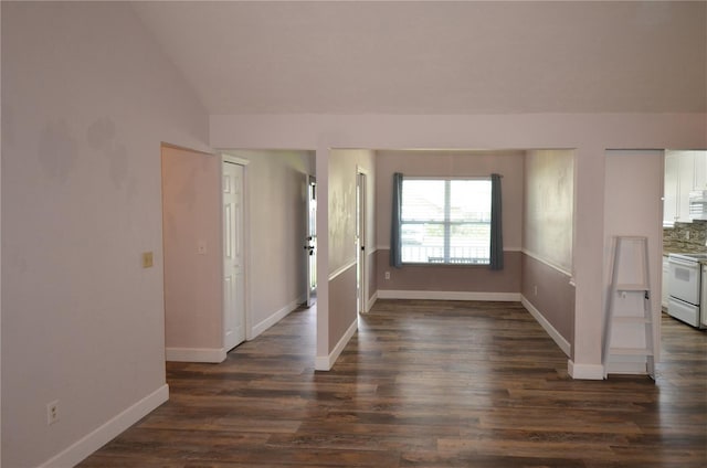 foyer featuring lofted ceiling, baseboards, and dark wood-type flooring