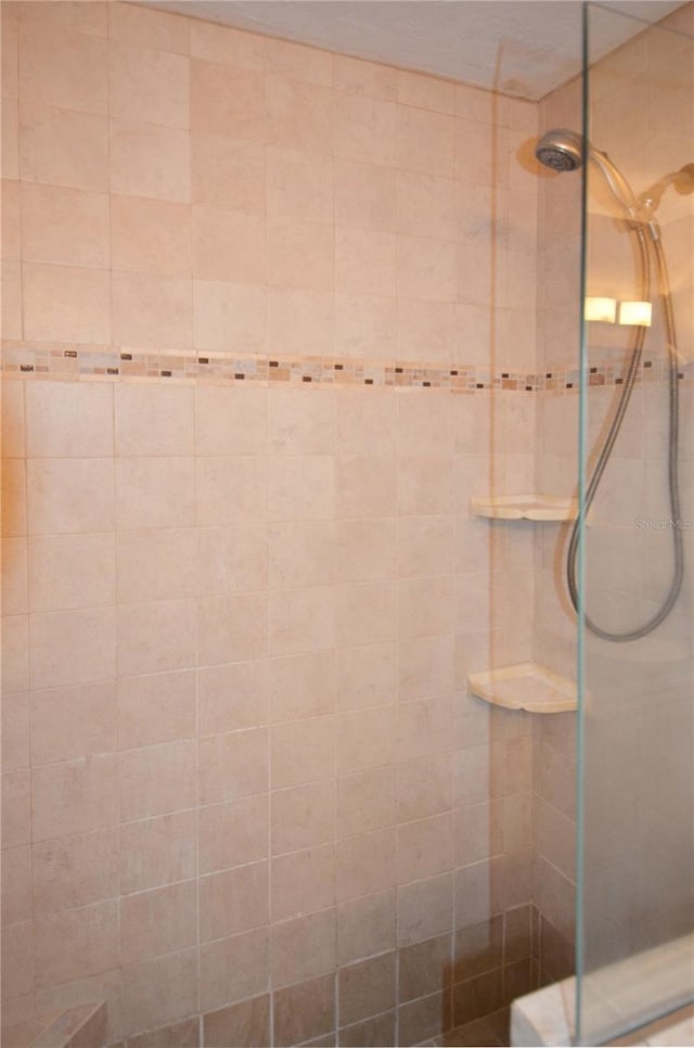 full bathroom with tiled shower
