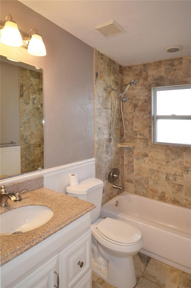 full bath with toilet, vanity, visible vents, tub / shower combination, and tile patterned floors