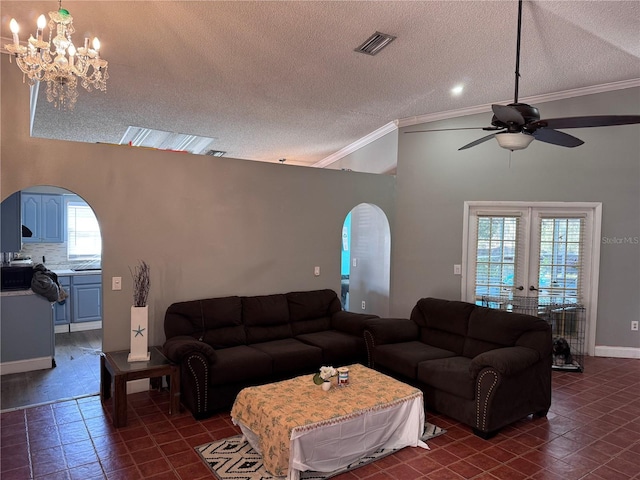 tiled living room with crown molding, french doors, and a textured ceiling